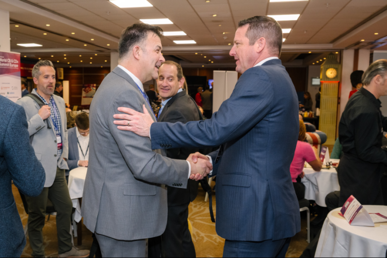 Conference attendees and industry partners networking and discussing innovations in mRNA therapeutics and drug delivery technologies.