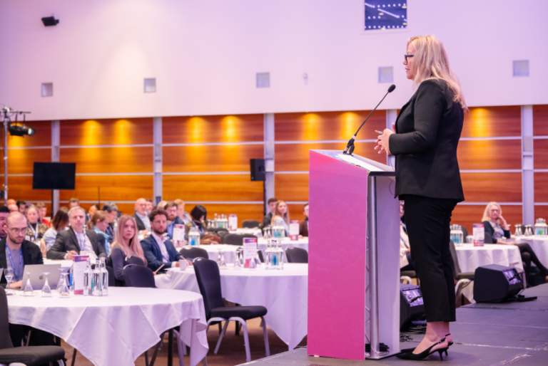 Conference speaker presenting insights on RNA therapeutics, mRNA development, and non-viral delivery innovation at a scientific industry summit.