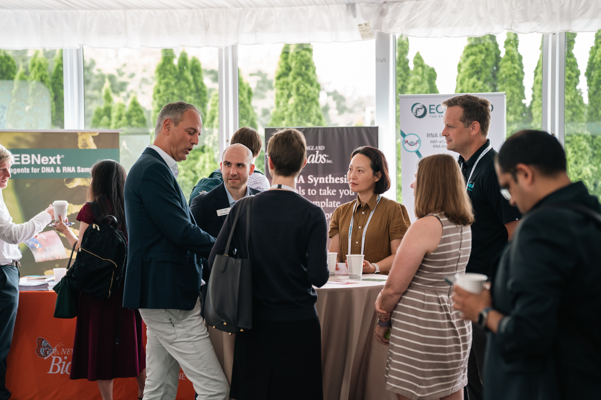Sponsor representative engaging with attendees at an exhibition stand during the 6th mRNA-Based Therapeutics & Non-Viral Delivery Summit Europe.